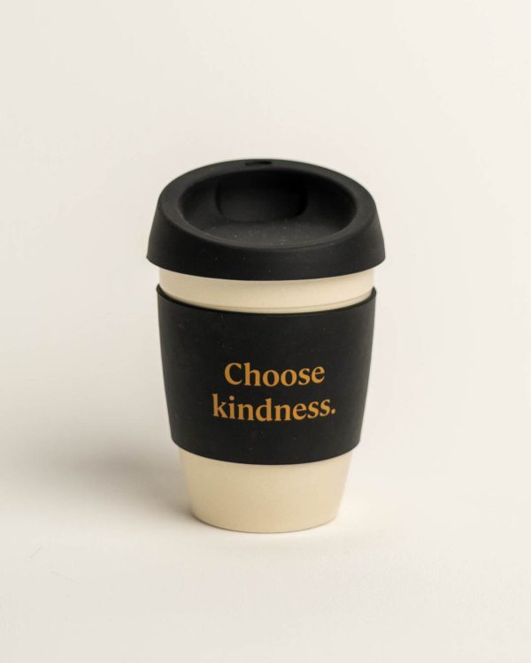 Beige reusable coffee cup with black band and lid. Band printed with 'Choose kindness'