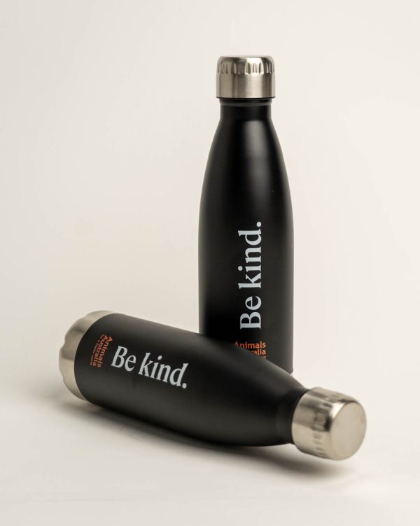 Two black drink bottles with silver base and lid. Print says 'Be kind' and includes the AA logo in orange