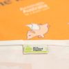 ACO certified organic label on the orange tea towel with flying pigs on it