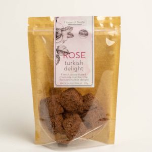 A packet of rose turkish delight treats on a plain background
