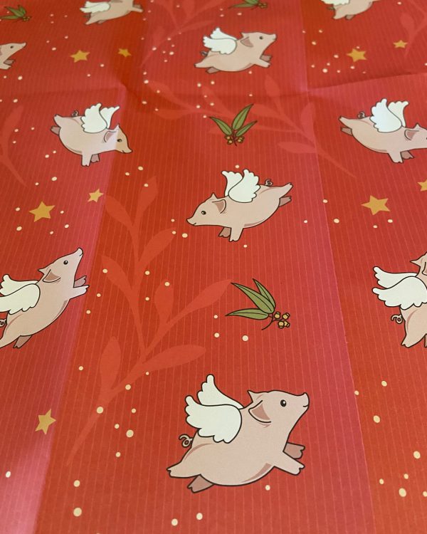 Red wrapping paper with flying pig print