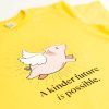 Yellow shirt with flying pig pic and quote - "A kinder future is possible."