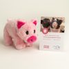Plush pig pictured with Valentines Day adoption certificate