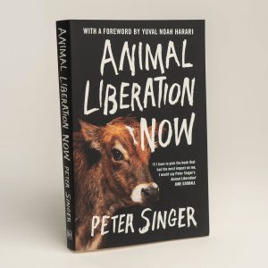 Front cover of 'Animal Liberation Now' book. Black with white writing and a picture of a calf