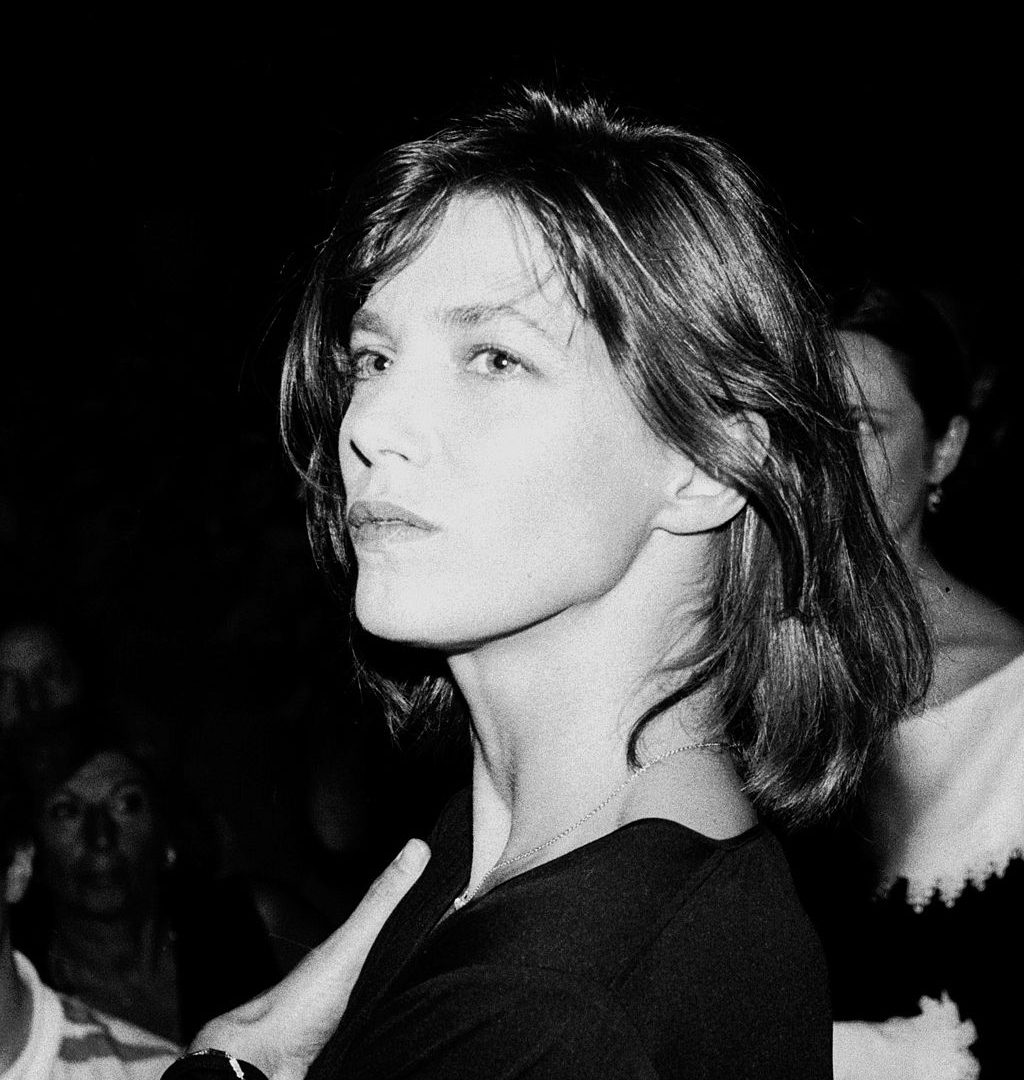 A black and white photo of a woman, with short hair, gazing just off camera.