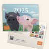 A 2025 Animals Australia calendar with an illustration of two piglets rubbing noses on the cover