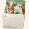 A page of the Animals Australia calendar with an illustration of two cows, one licking the others face.