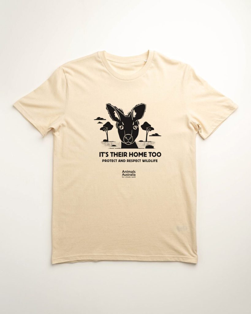 Black print of a kangaroo with the writing "it's their home too. Respect and protect wildlife" on a natural coloured tee