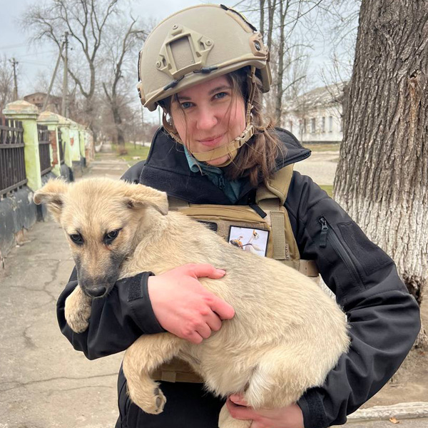 A soldier in Ukraine holds a dog.