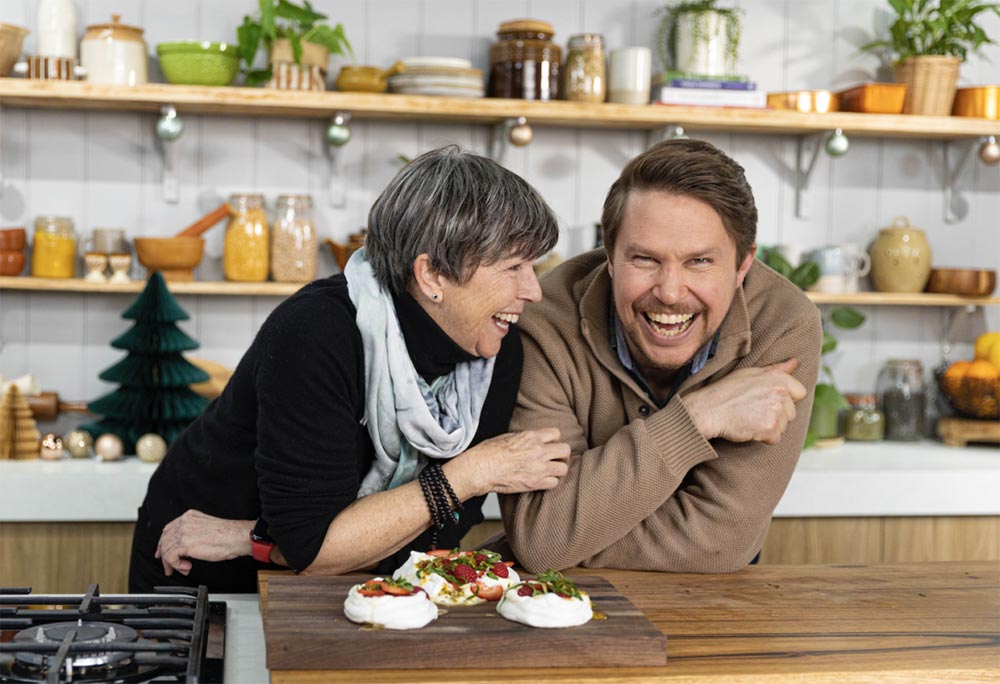 Simon Toohey and his mum, Therese, stand behind the bench on the set of 'Freshly Picked with Simon Toohey'.