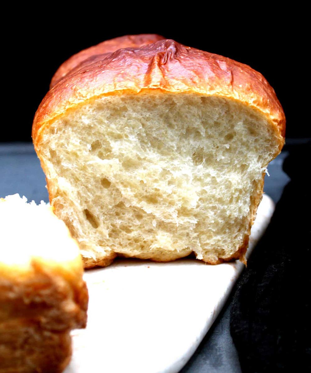 A loaf of brioche has been cut to show how soft and fluffy the centre is.