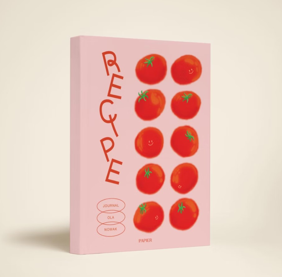 A pink hardocover book is stood in front of a cream background. It has been designed with animated tomatoes.